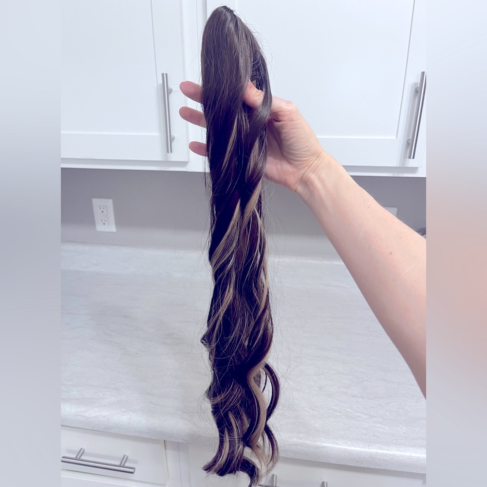 Brown hair extension ponytail with blonde highlights. New. Never worn.